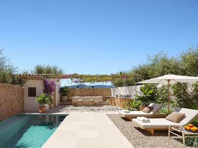 Modern turquoise pool with wooden sun loungers, outdoor dining under a flowering pergola, and rustic stone walls.