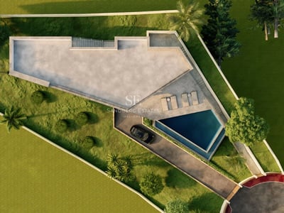 Exterior view of a modern villa with a pool, surrounded by greenery. Minimalist architectural design and high-quality finishes.