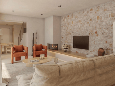 Modern living room featuring an exposed stone wall, burnt orange armchairs, a beige sofa, and a built-in fireplace.