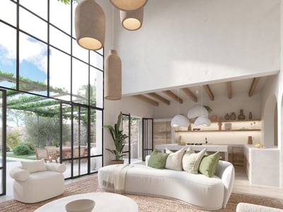 Spacious white living room with curved sofas, jute rug, and floor-to-ceiling windows overlooking a lush terrace.