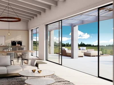 Salon lumineux avec poutres apparentes, canapés modernes et grandes baies vitrées ouvrant sur une terrasse ensoleillée.