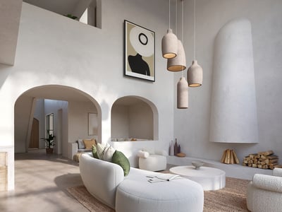 Elegant white living room featuring curved bouclé sofas, a sculptural fireplace, and textured plaster arches.