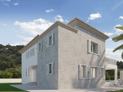 Two-story stone villa with white shutters and terracotta roof next to palm trees under a blue sky.
