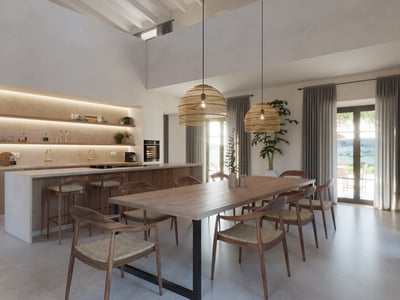 Spacious dining area with a long wooden table, wicker pendant lights, and a modern open-plan kitchen in the background.