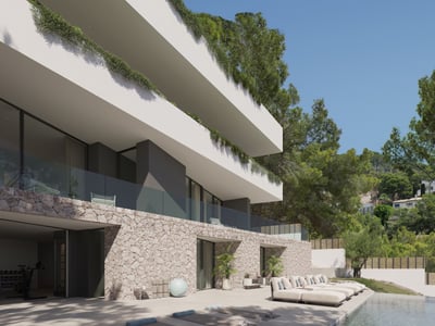 Terraza con piscina, tumbonas y esterillas de yoga frente a una moderna villa de piedra y blanco.