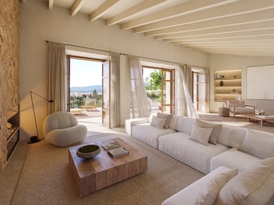 Spacious living room with white sofas, stone wall, ceiling beams, and open doors to a terrace with mountain views.