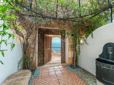 Expansive terrace featuring an infinity pool with panoramic views. Modern design, elegant outdoor furniture, and manicured landscaping.