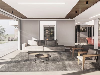 Minimalistiskt vardagsrum med grå soffa, träfåtöljer och stora glaspartier från golv till tak.