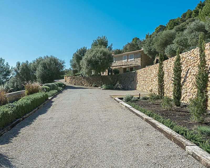 Spacious balcony with panoramic sea views. Glass railing, wooden floors, and modern furniture. Warm lighting and relaxing atmosphere.