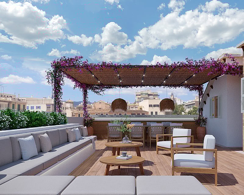 Spacious wooden rooftop terrace with grey sofas, bougainvillea-covered pergola, and outdoor dining area overlooking the city.