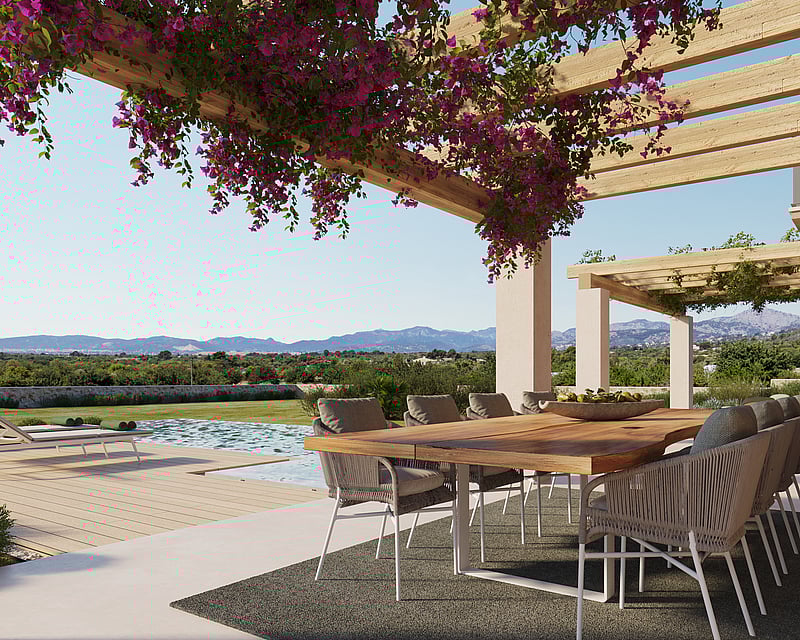 Outdoor wooden dining table under a pergola with purple flowers, overlooking a pool and mountains.