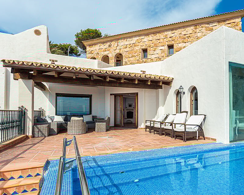 Spacious terrace with infinity pool and panoramic views. Modern design, elegant outdoor furniture, and lush vegetation.