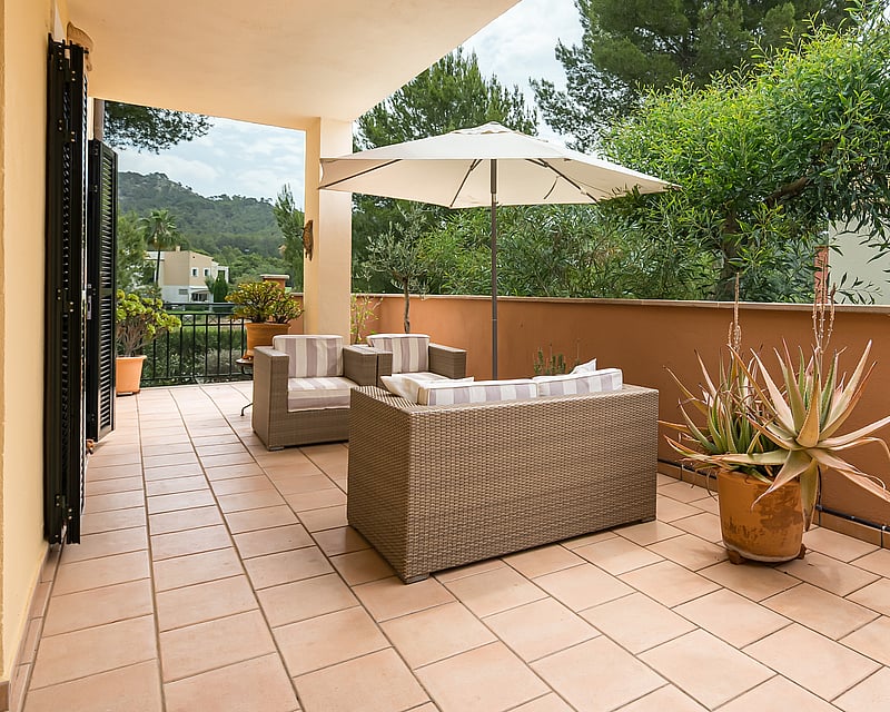 Aerial view of modern villa featuring infinity pool, spacious terraces, minimalist design, and lush gardens. High-quality finishes.