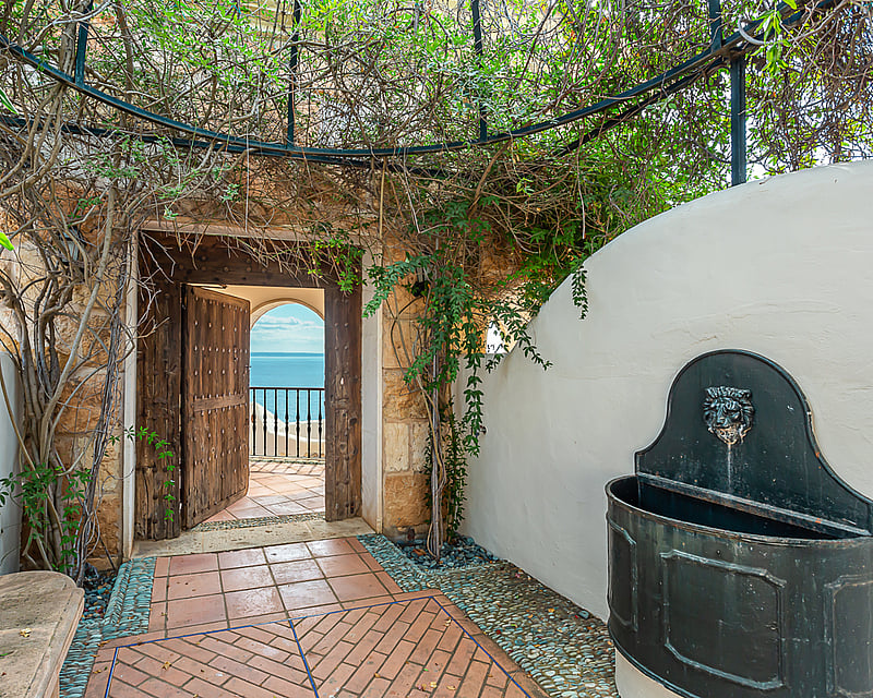 Expansive terrace featuring an infinity pool with panoramic views. Modern design, elegant outdoor furniture, and manicured landscaping.