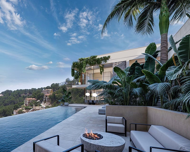 Luxury infinity pool overlooking a coastal bay with a stone terrace, outdoor fire pit lounge, and modern villa architecture.
