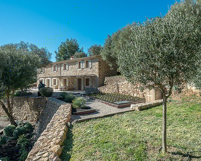 Spacious living room featuring expansive windows, designer sofas, modern fireplace, and panoramic views. Pendant lights and light wood flooring.