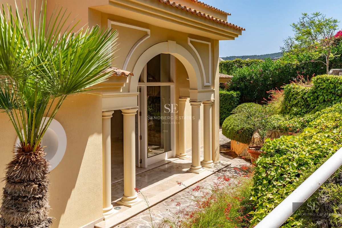 Spacious living room featuring a fireplace, large windows, and panoramic views. Leather sofa, designer rug, and modern decor.