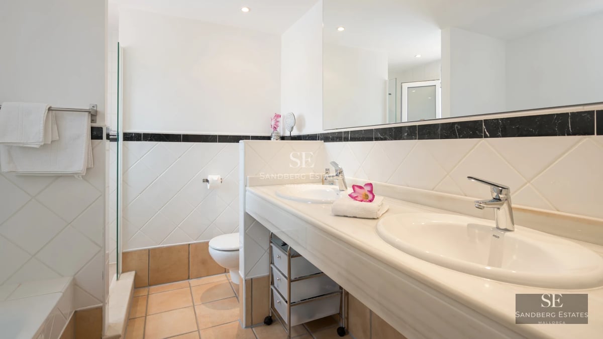 Exterior view of a luxurious villa with a pool, lush garden and modern architecture. Warm ambient lighting.