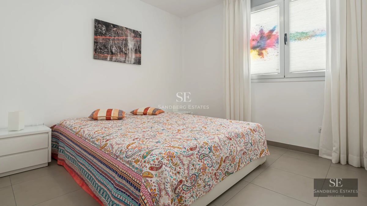 Exterior view of a modern villa with a pool, lush garden, and minimalist architecture. Warm lighting at sunset.