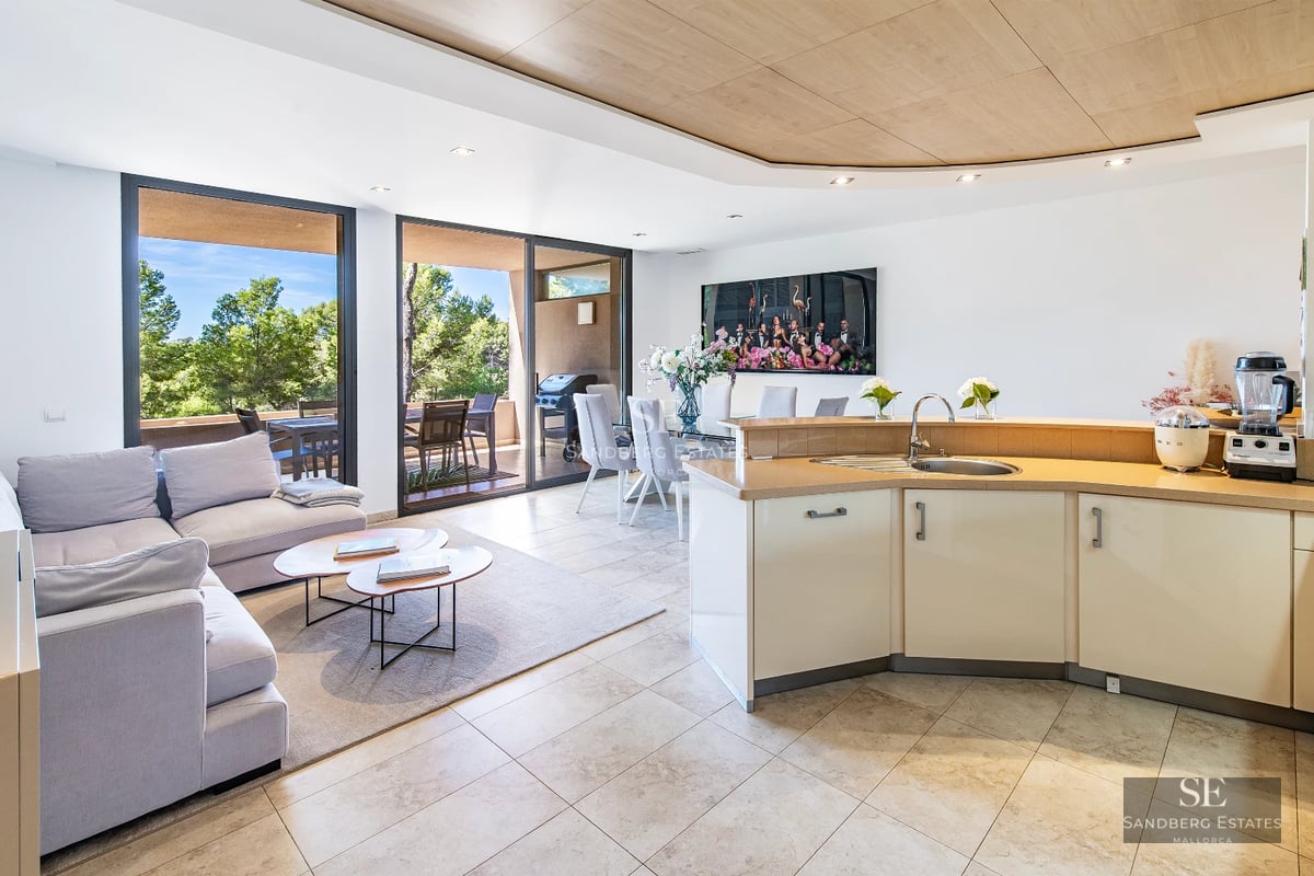 View of modern villa with infinity pool. Minimalist architecture, large windows, and lush natural environment.