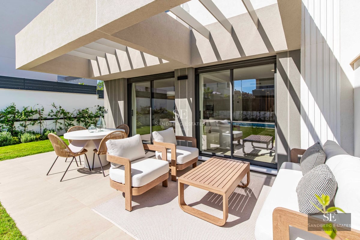 Modern exterior view with reflecting pool, large windows, glass balconies, and minimalist design. Soft ambient lighting.