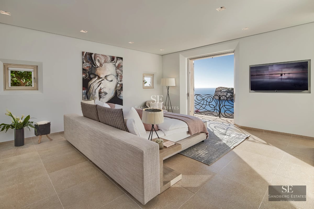 Modern exterior with reflective pool, manicured garden, and large windows offering brightness and panoramic views.