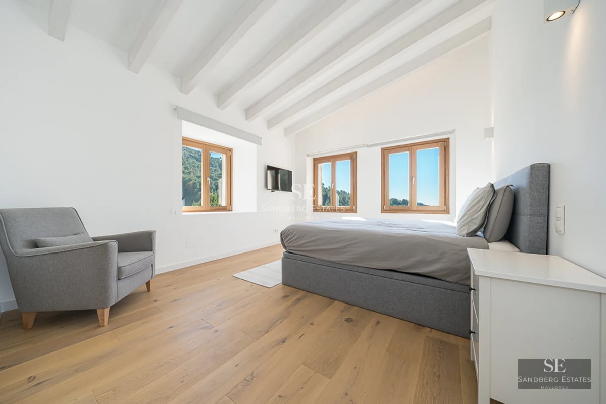 Expansive terrace with pool, sun loungers, landscaped garden, and view. Modern architecture with large windows.