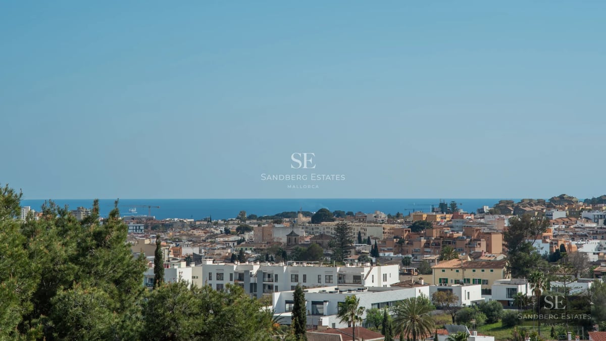 View of a modern villa featuring a pool, large windows, a sunny terrace, and lush greenery. Contemporary design and high-end finishes.
