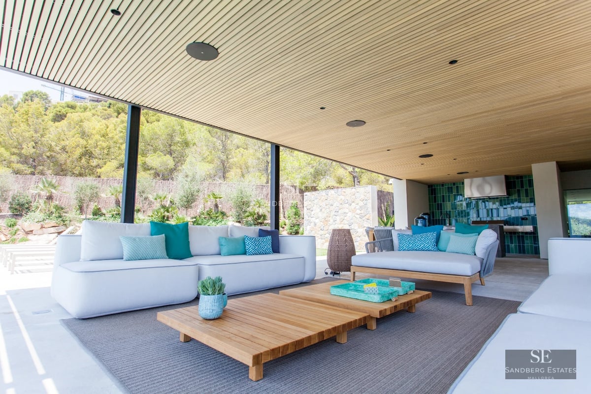 Spacious living room with pool access. Panoramic windows, wooden floors, modern design. Natural lighting and designer furniture.