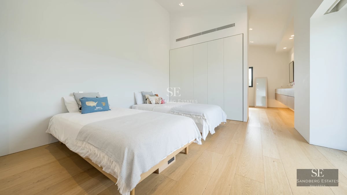 Bright interior featuring expansive windows, sea views, hardwood floors, and modern décor. Open and inviting space.