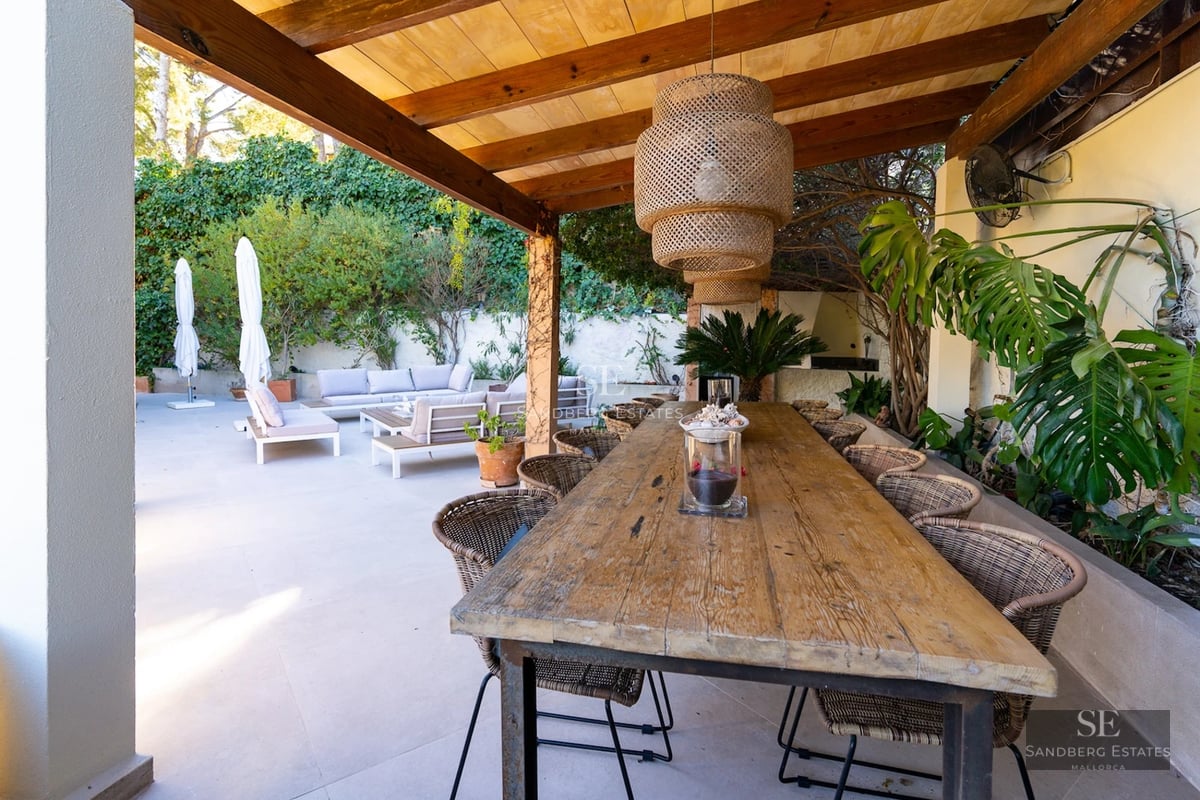 Exterior view of a modern villa featuring a pool, expansive garden, and minimalist design. Warm ambient lighting and lush vegetation.