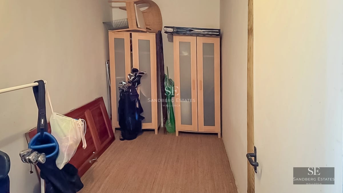 View of modern infinity pool surrounded by lush greenery. Sleek and minimalist design. Soft ambient lighting enhances the space.