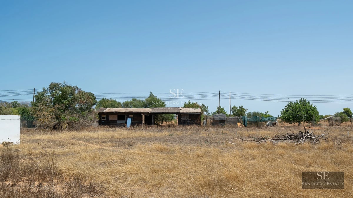 Large balcony with sea view, glass railing, modern furniture. Bright and minimalist interior visible.
