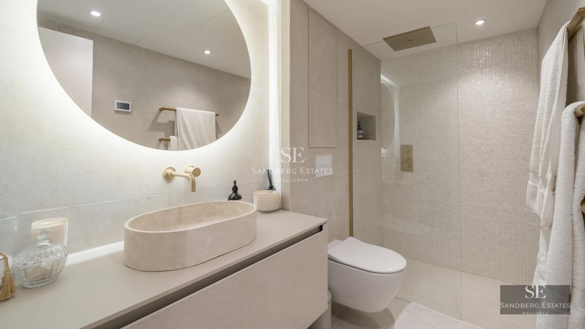 View of an infinity pool merging with the sea. Modern design with large windows and sunny terrace. Luxury and comfort outdoors.