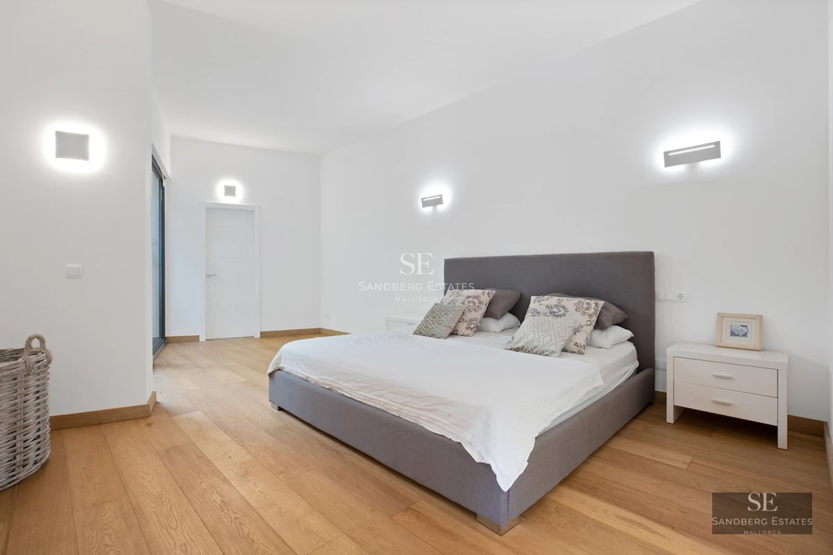 Exterior view of a modern villa with infinity pool, manicured garden, and expansive terraces. Minimalist architecture with large windows.