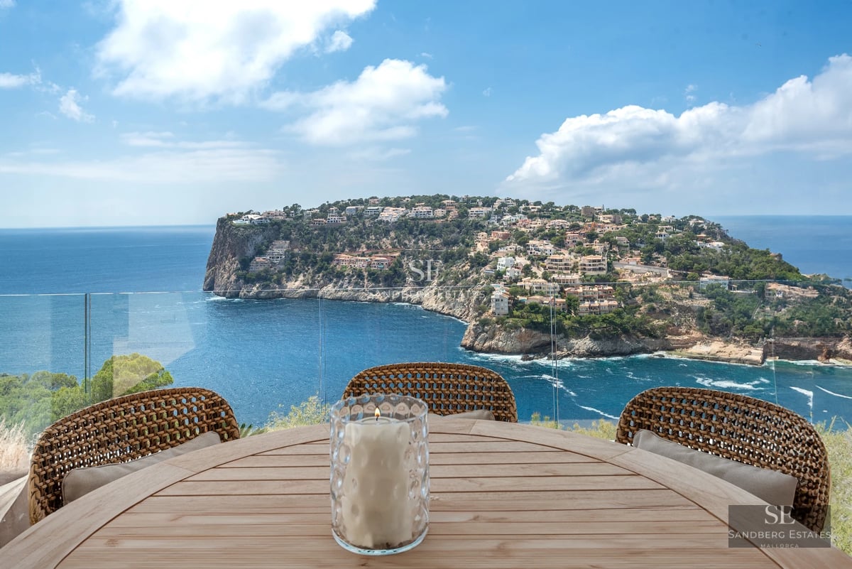 Exterior view of a modern villa with a pool, landscaped garden, and spacious terraces. Contemporary architecture featuring clean lines and large windows.