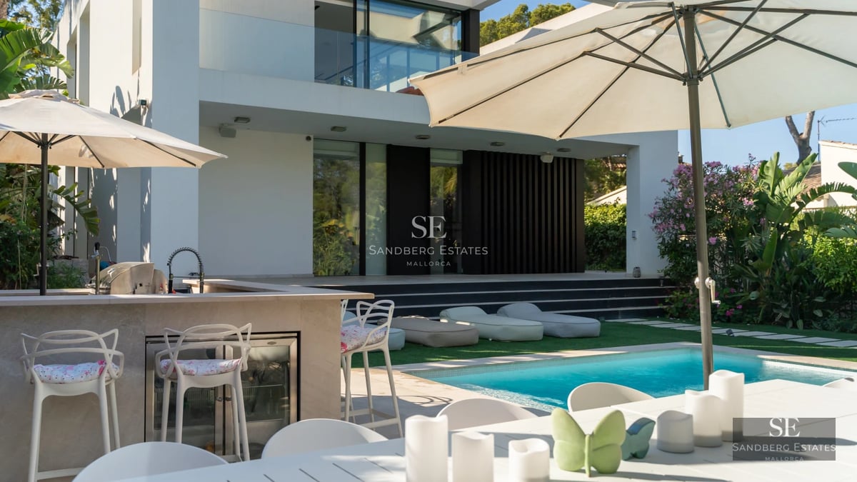 Expansive terrace with infinity pool and panoramic ocean views. Modern design featuring minimalist and elegant outdoor furniture.