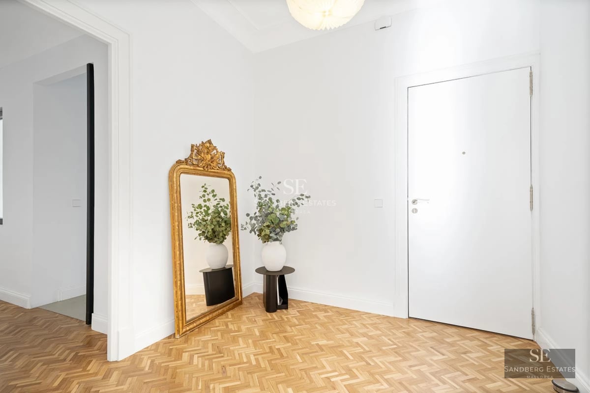 Aerial view of modern villa featuring a reflective pool, lush garden, and spacious terraces. Minimalist architectural design.
