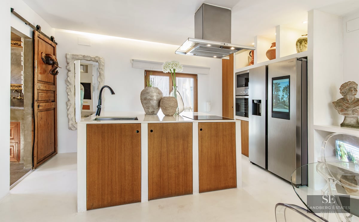 Contemporary kitchen featuring a wooden island, white countertops, and a stainless steel smart refrigerator.