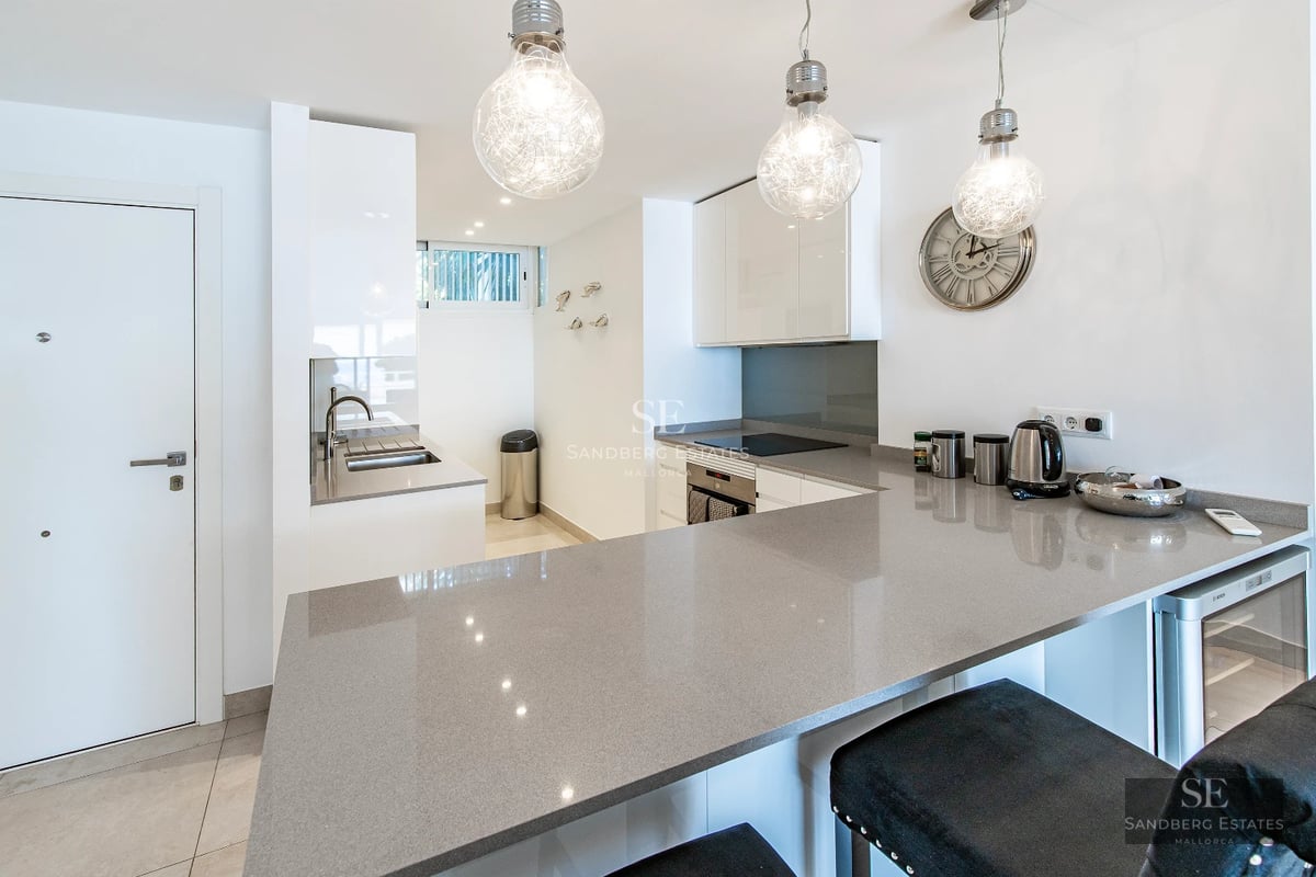 Exterior view of a modern villa with an infinity pool. Minimalist architecture, large windows, and lush landscaping.