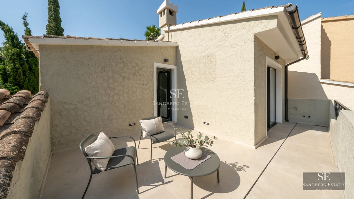 Spacious living room featuring floor-to-ceiling windows, a modern fireplace, and minimalist design. Panoramic views and natural light.