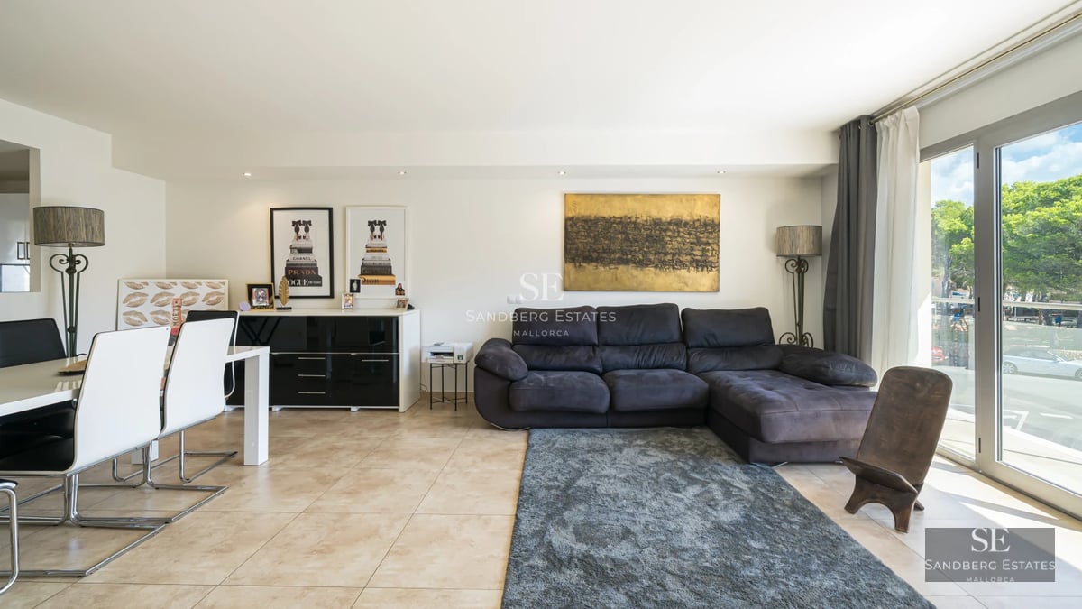 Villa view featuring infinity pool, sun loungers, and lush vegetation. Modern architecture with large windows and terrace. Relaxing landscape.