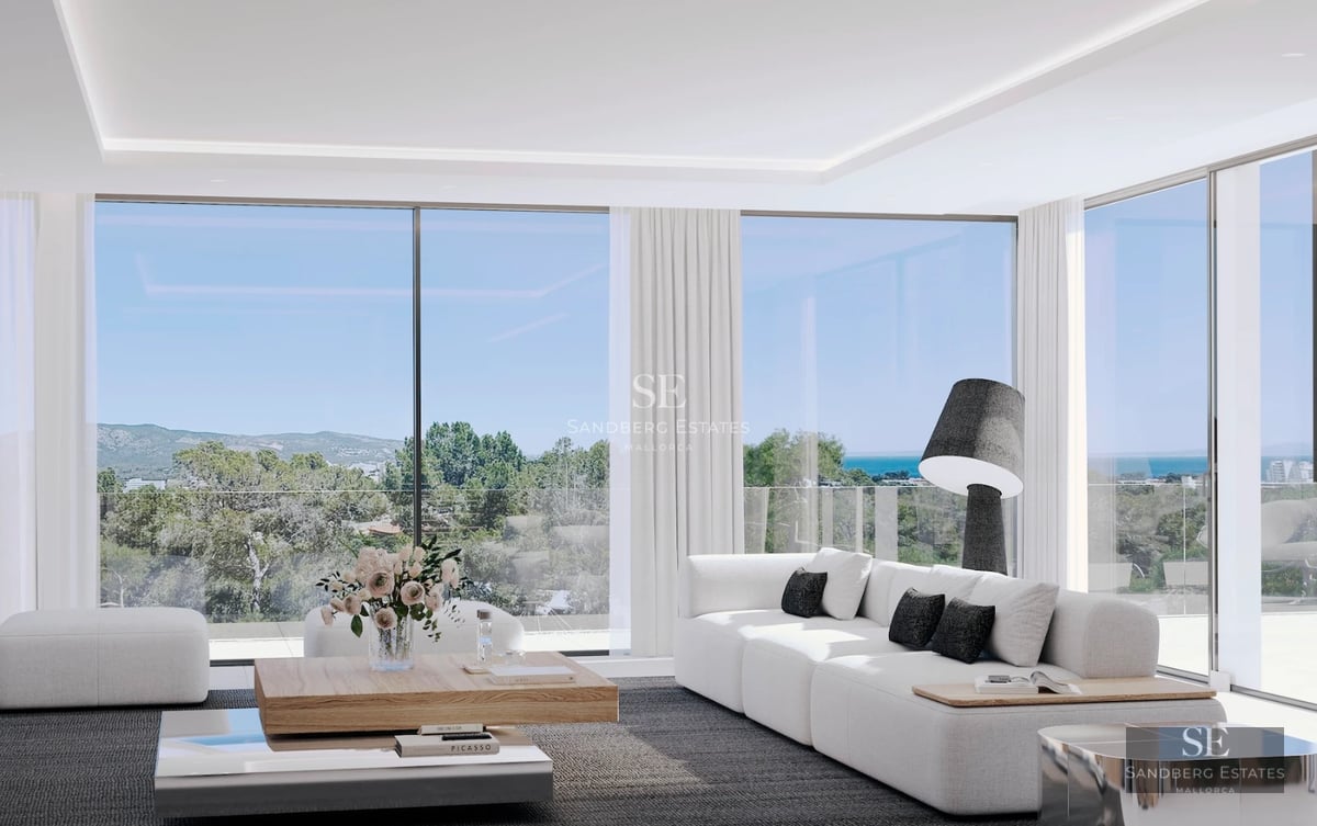 Spacious living room with fireplace, floor-to-ceiling windows, and panoramic views. Modern and elegant interior design.