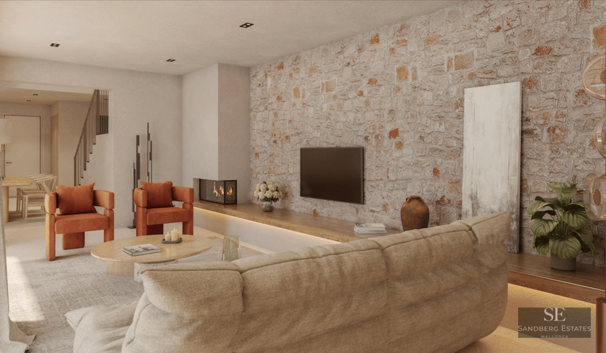 Modern living room featuring an exposed stone wall, burnt orange armchairs, a beige sofa, and a built-in fireplace.