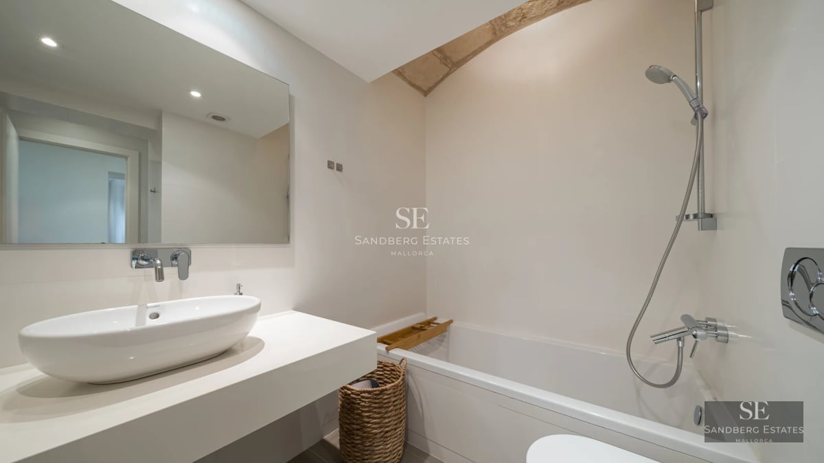 Bright living room featuring expansive windows, light wood floors, and modern design. Panoramic sea views and large balcony.