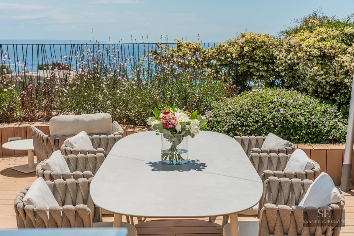 Exterior view of modern villa with reflecting pool. Minimalist architecture, large windows, and lush greenery.