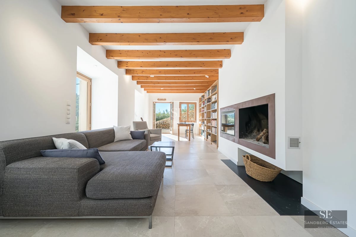 Expansive terrace with an infinity pool. Modern design featuring sun loungers, ocean views, and minimalist architecture.