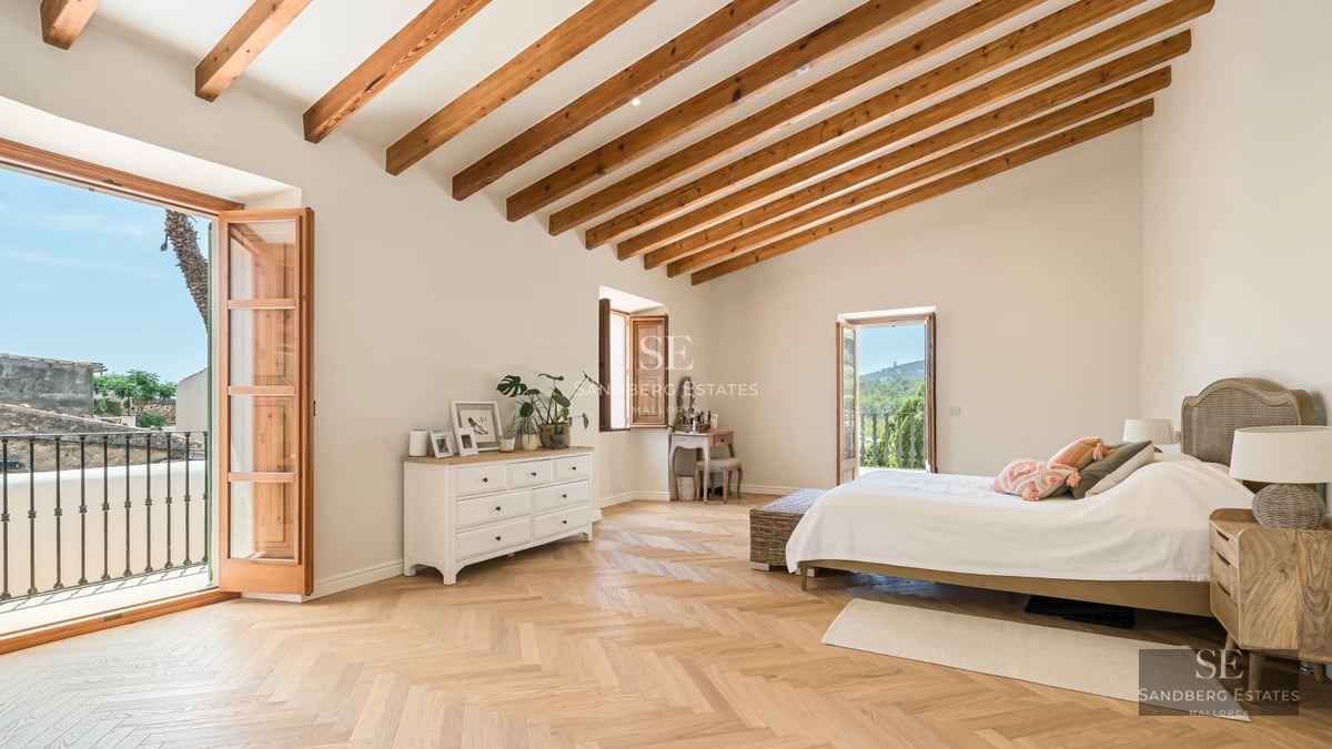Bright living room featuring floor-to-ceiling windows with sea view. Leather sofa, modern coffee table, designer rug. Warm lighting, luxury finishes.
