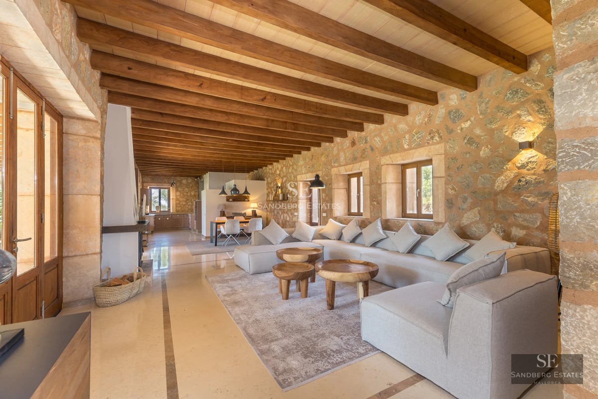 Expansive terrace featuring an infinity pool, sun loungers, and panoramic views. Modern, minimalist design with touches of greenery.