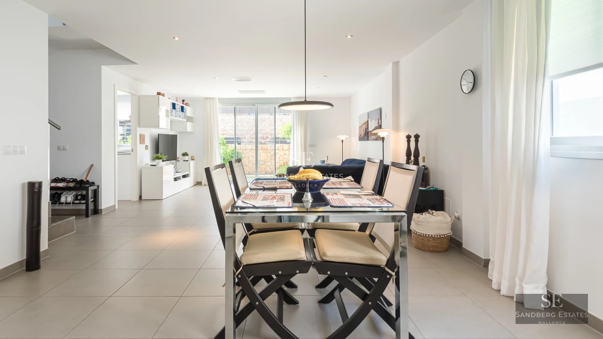 Exterior view of a modern house featuring a swimming pool, manicured lawn, and minimalist architecture. Bright and elegant design.